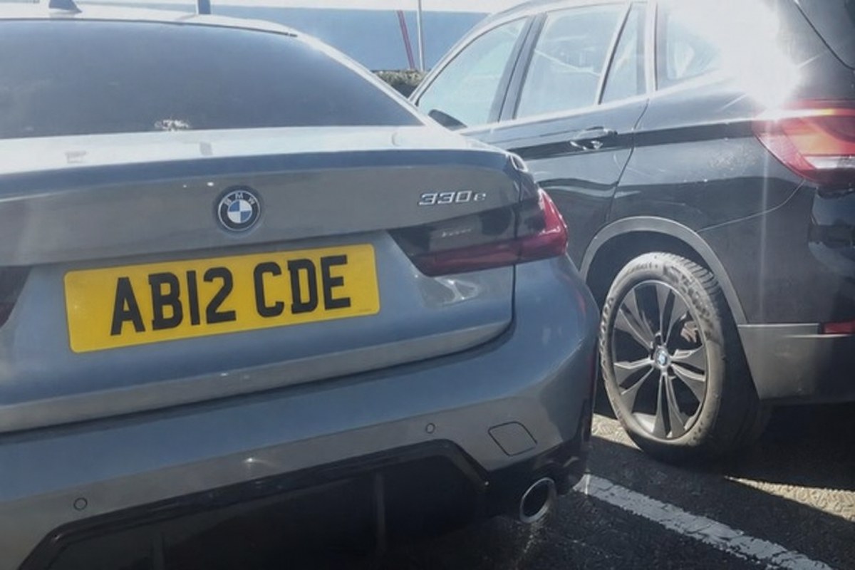 The rear of a grey BMW 3 Series in a car park, as the camera captured it